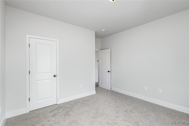 unfurnished bedroom with light carpet