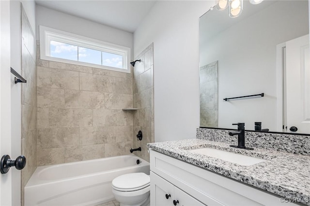 full bathroom with tiled shower / bath combo, vanity, and toilet