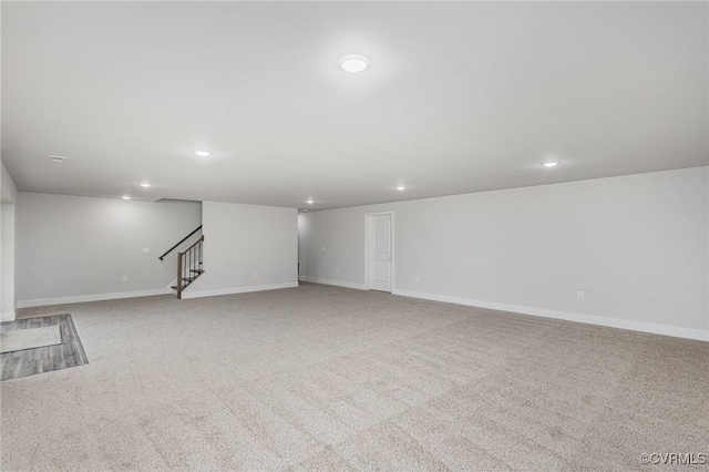 basement featuring light carpet