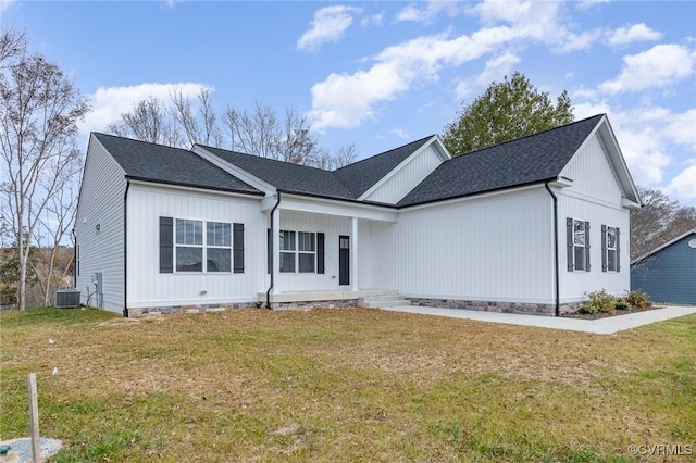 view of front of property featuring covered porch, central air condition unit, and a front lawn