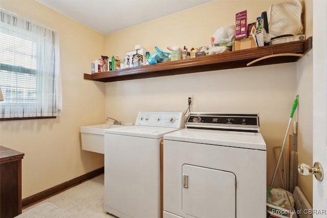 washroom featuring sink and washing machine and clothes dryer