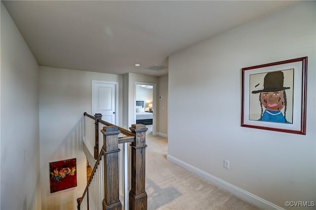 hallway featuring light carpet