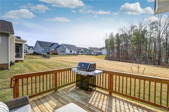 wooden terrace featuring a yard and area for grilling