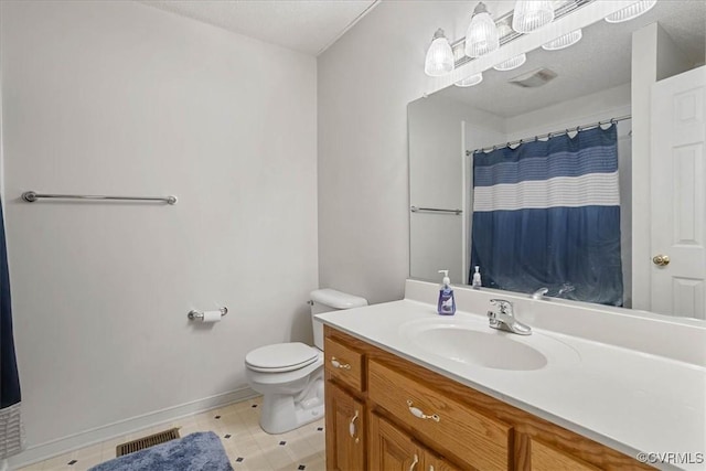 bathroom featuring a textured ceiling, toilet, vanity, and walk in shower