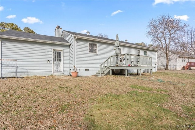 rear view of property featuring a lawn and a wooden deck