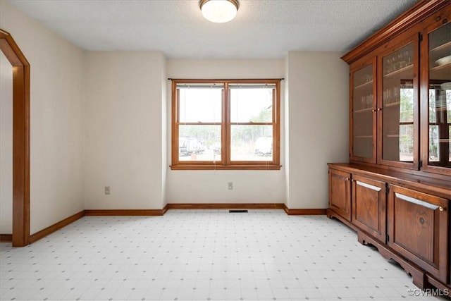 spare room with a textured ceiling