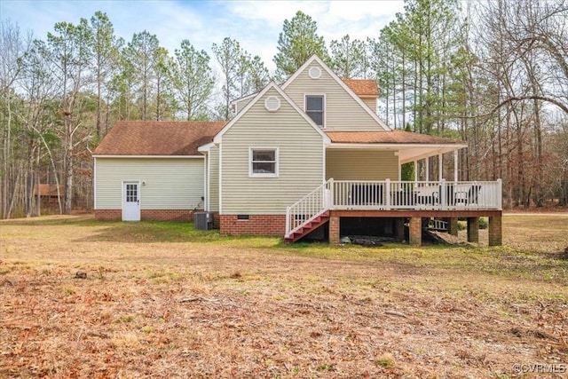 back of property with central AC unit, a yard, and a wooden deck