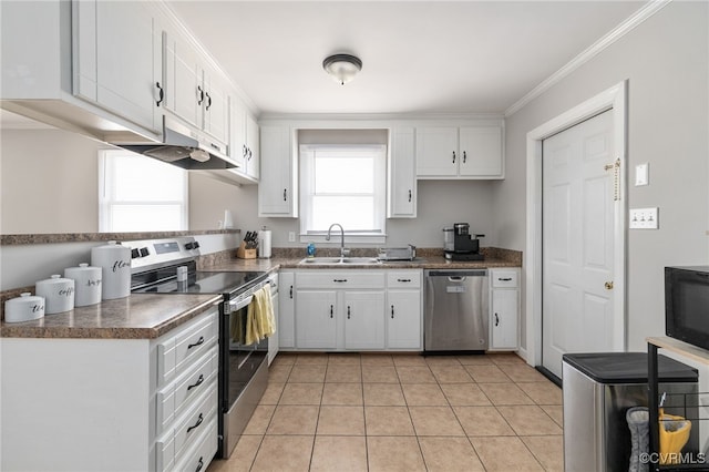 kitchen featuring appliances with stainless steel finishes, ornamental molding, light tile patterned floors, sink, and white cabinetry