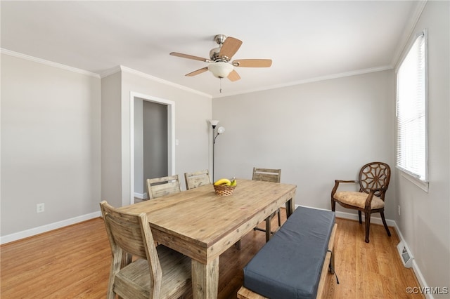 dining area with ceiling fan, light wood-type flooring, and crown molding