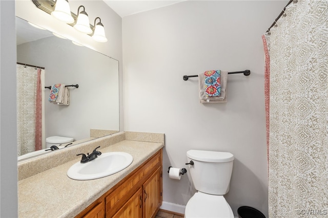 bathroom with toilet and vanity