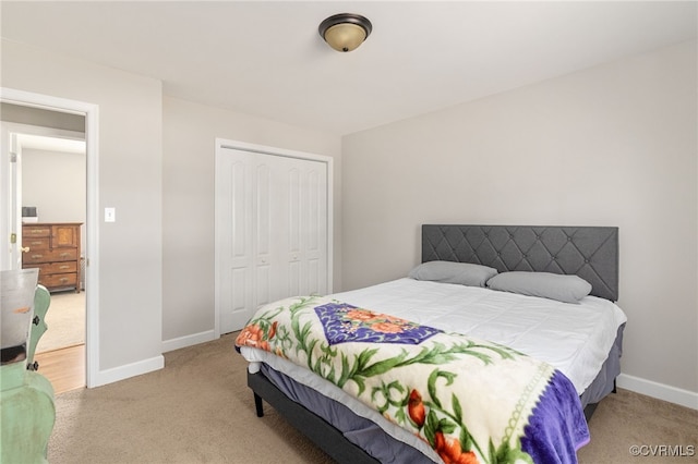 bedroom with a closet and light colored carpet