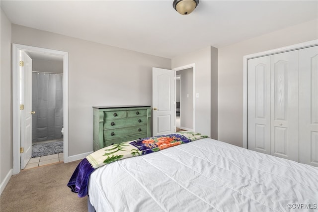 carpeted bedroom with a closet and ensuite bathroom