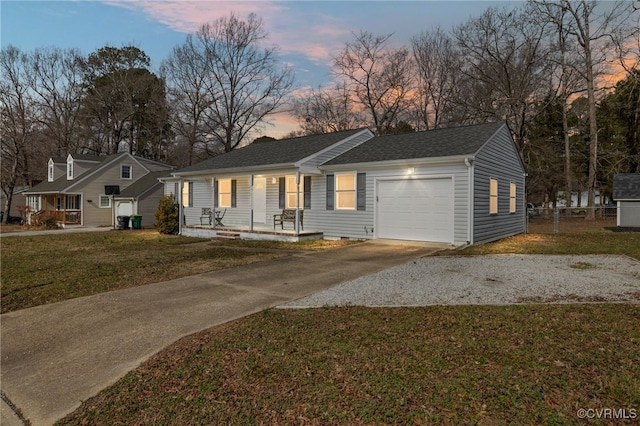 single story home featuring a garage and a yard