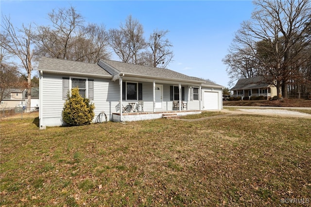 ranch-style house featuring a front lawn, a garage, and covered porch