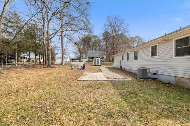 view of yard with central AC unit and a shed