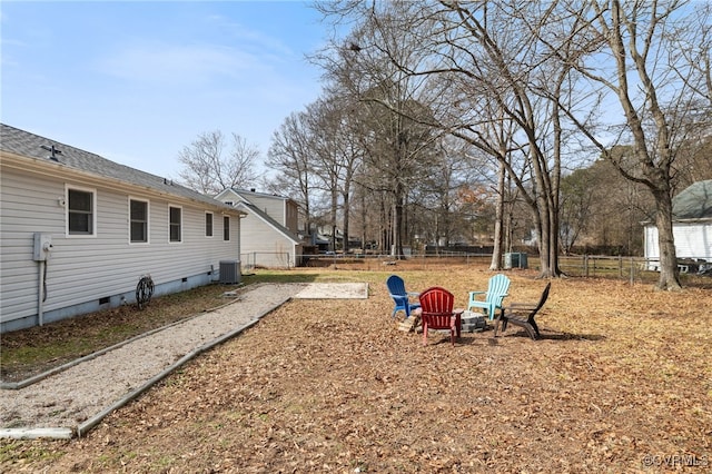 view of yard featuring an outdoor fire pit and central air condition unit