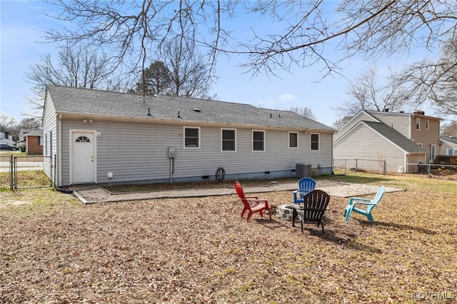 back of house featuring central AC and a fire pit