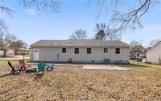 back of property featuring central AC unit and a fire pit