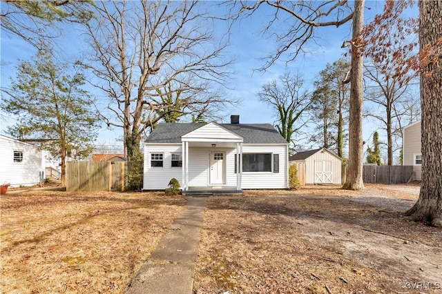 view of front of home with a storage shed