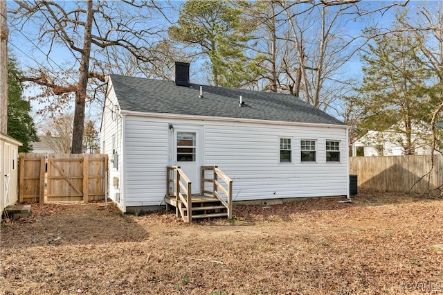 rear view of property featuring central AC unit