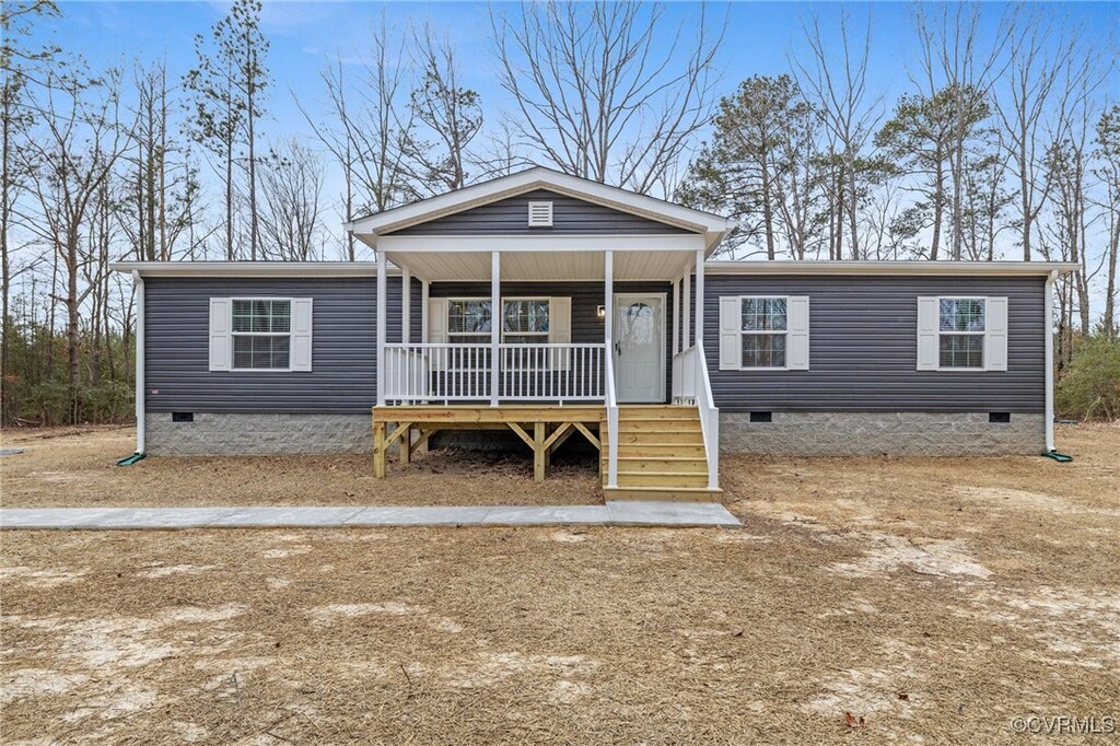 manufactured / mobile home featuring crawl space and covered porch