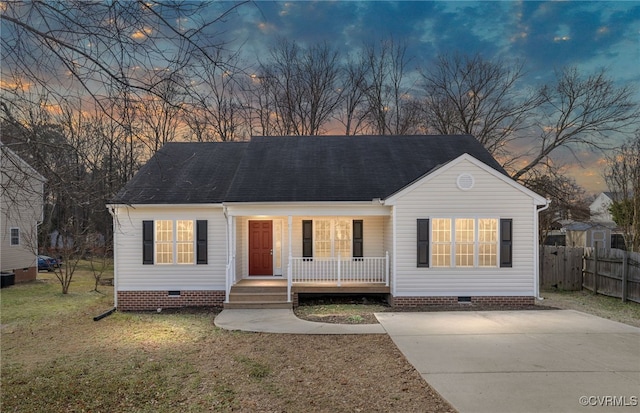 view of front of home featuring covered porch and a lawn