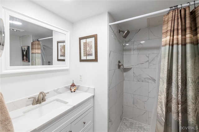 bathroom featuring vanity and a marble finish shower