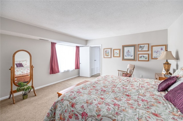 bedroom featuring light carpet, baseboards, visible vents, and a textured ceiling