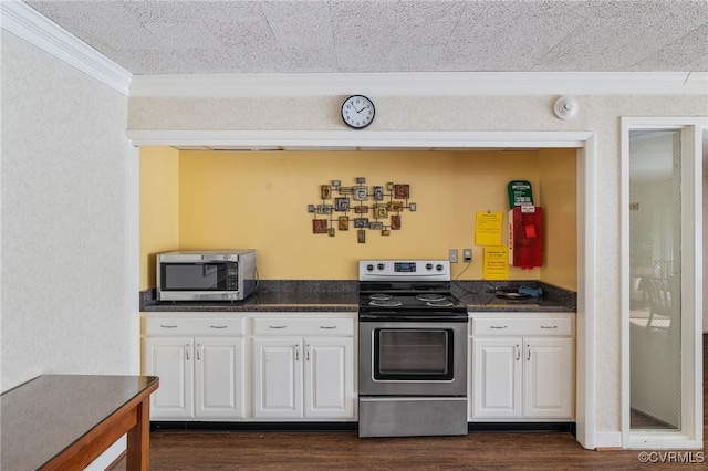 kitchen with white cabinets, dark countertops, dark wood-style floors, appliances with stainless steel finishes, and ornamental molding