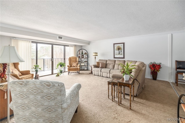 living room with visible vents, a textured ceiling, and light colored carpet