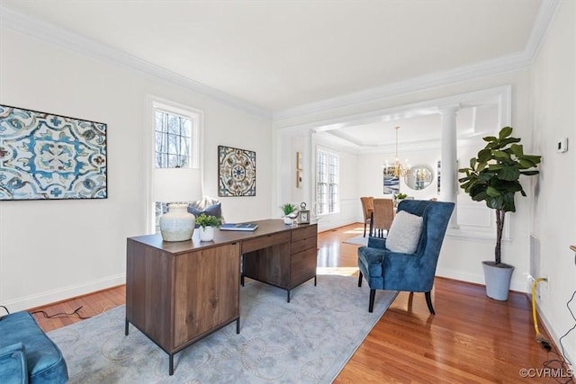 office featuring ornamental molding, a notable chandelier, and wood finished floors