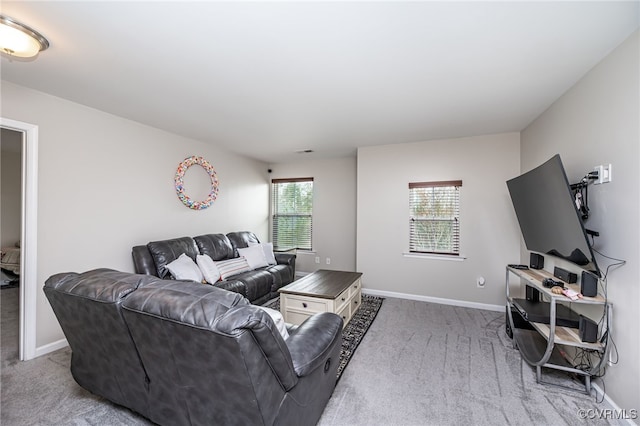 carpeted living room with baseboards