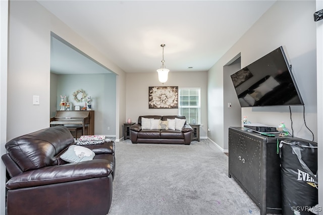 living area featuring baseboards and carpet floors