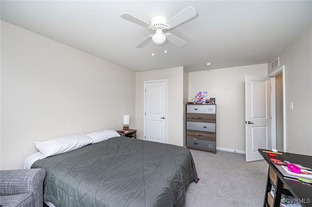 bedroom with light carpet, visible vents, baseboards, and a ceiling fan