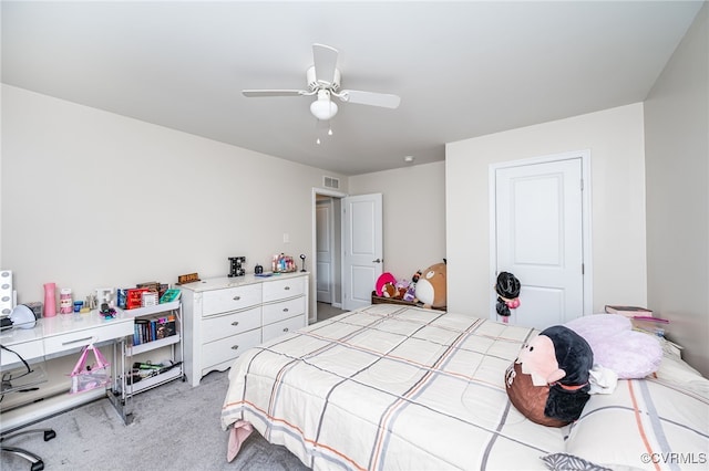 bedroom with visible vents, light carpet, and a ceiling fan