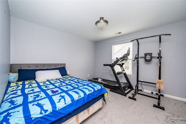 carpeted bedroom with visible vents and baseboards