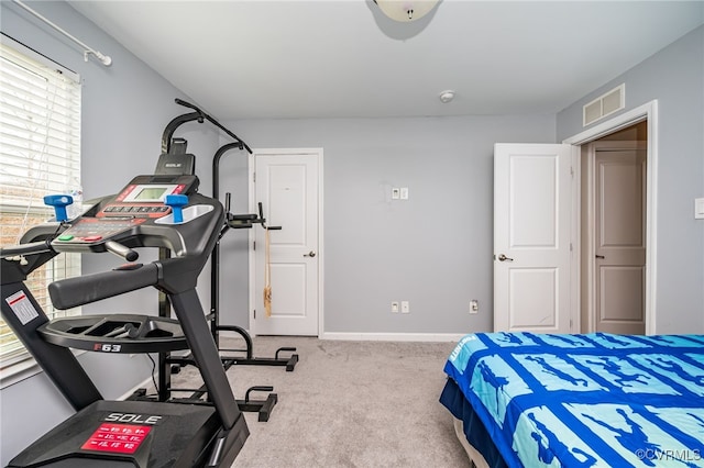 carpeted bedroom with visible vents and baseboards