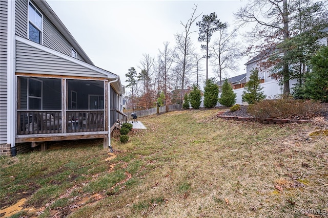 view of yard with fence and a sunroom