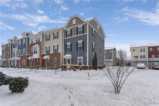 townhome / multi-family property featuring board and batten siding and brick siding