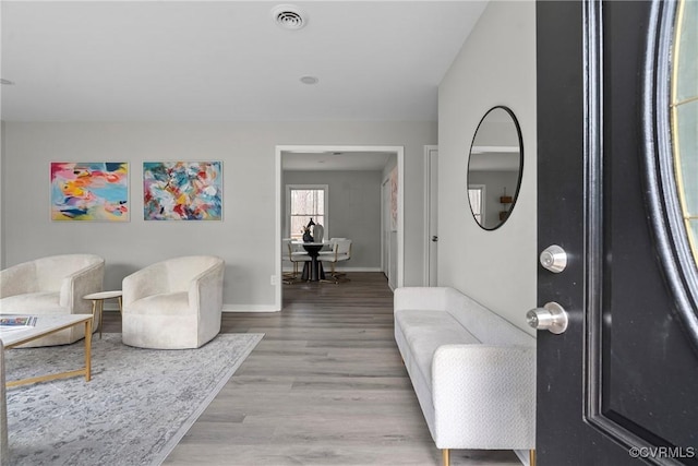 interior space with visible vents, baseboards, and wood finished floors