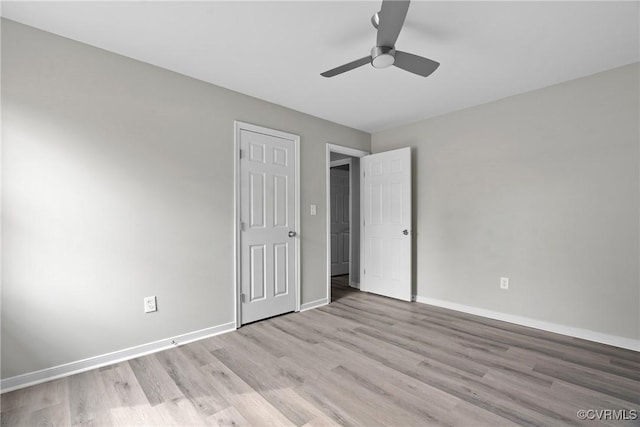 unfurnished bedroom featuring wood finished floors, a ceiling fan, and baseboards