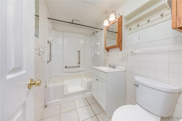 full bathroom with shower / tub combination, tile walls, vanity, toilet, and tile patterned floors