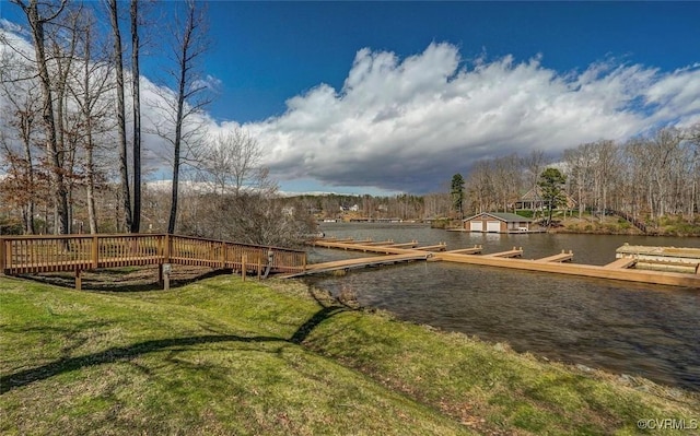 view of yard with a dock and a water view