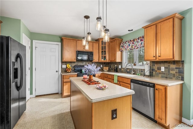 kitchen featuring a center island, black appliances, sink, backsplash, and pendant lighting