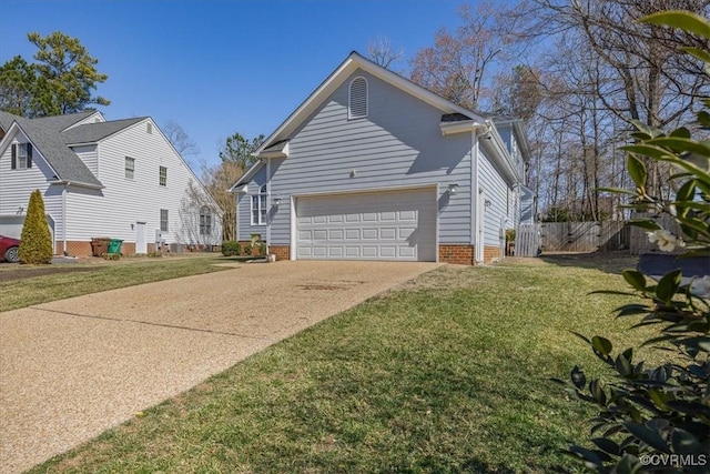 view of side of home with a yard, fence, and driveway