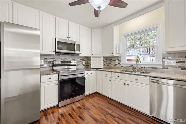 kitchen featuring a sink, white cabinets, dark wood-style floors, and stainless steel appliances