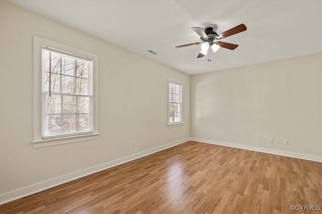 unfurnished room with baseboards, light wood finished floors, and ceiling fan