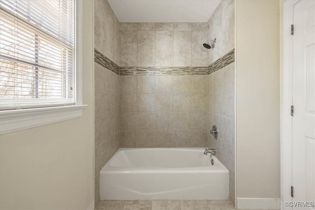 bathroom with tub / shower combination, baseboards, and tile patterned floors