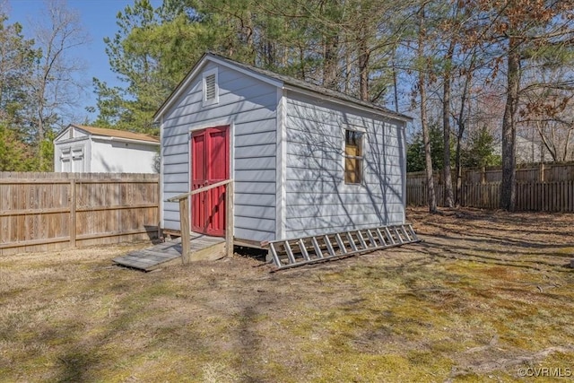 view of shed with a fenced backyard