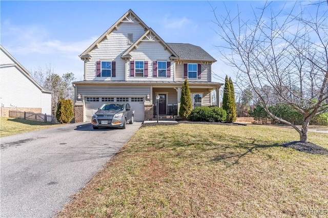 view of front of house with a garage, covered porch, and a front yard